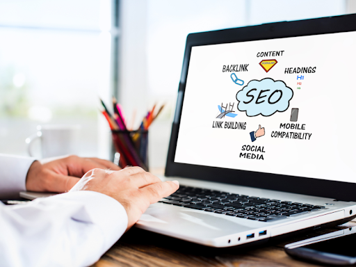 Laptop screen showing SEO Services for B2B, which include content, backlinks, mobile UX, and social media