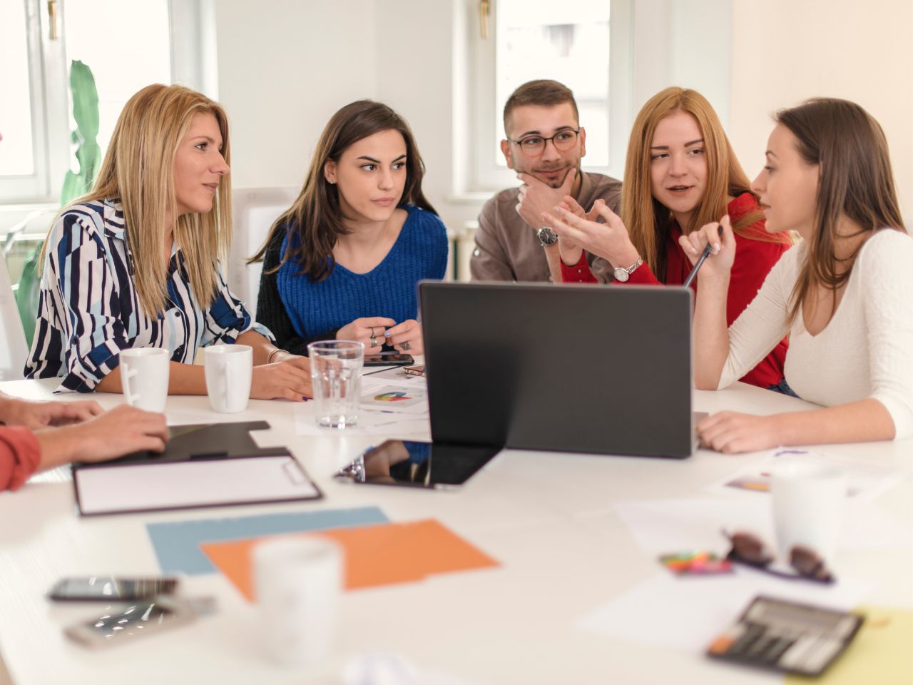 B2B marketing team discussing strategies based on how long SEO takes to show results.